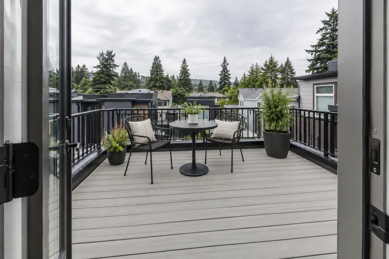 Compact rooftop deck with gray boards and black railing