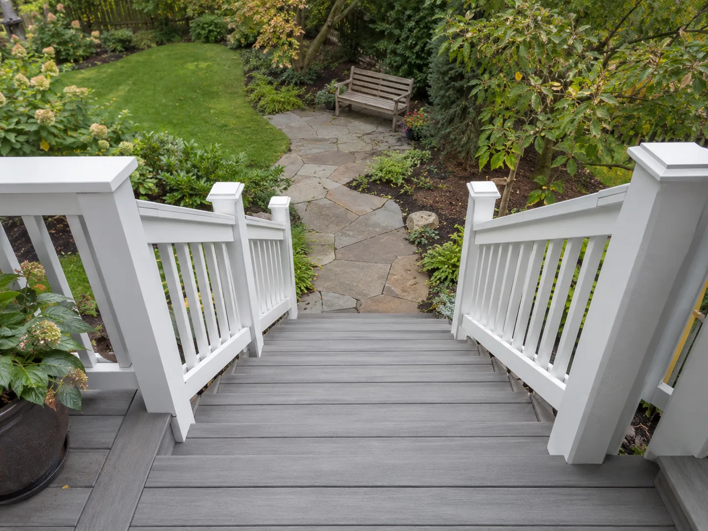 Gray composite deck stairs with white handrails